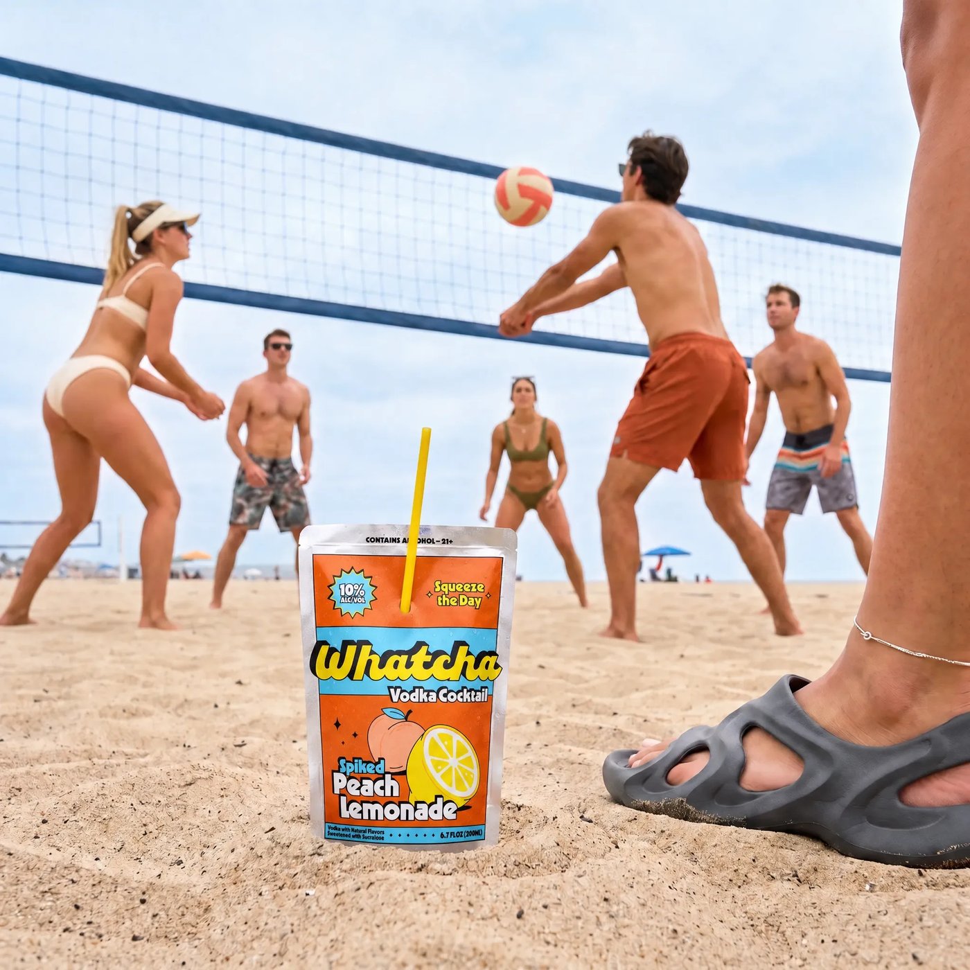 Friends playing beach volleyball with a Whatcha Spiked Peach Lemonade pouch in the sand